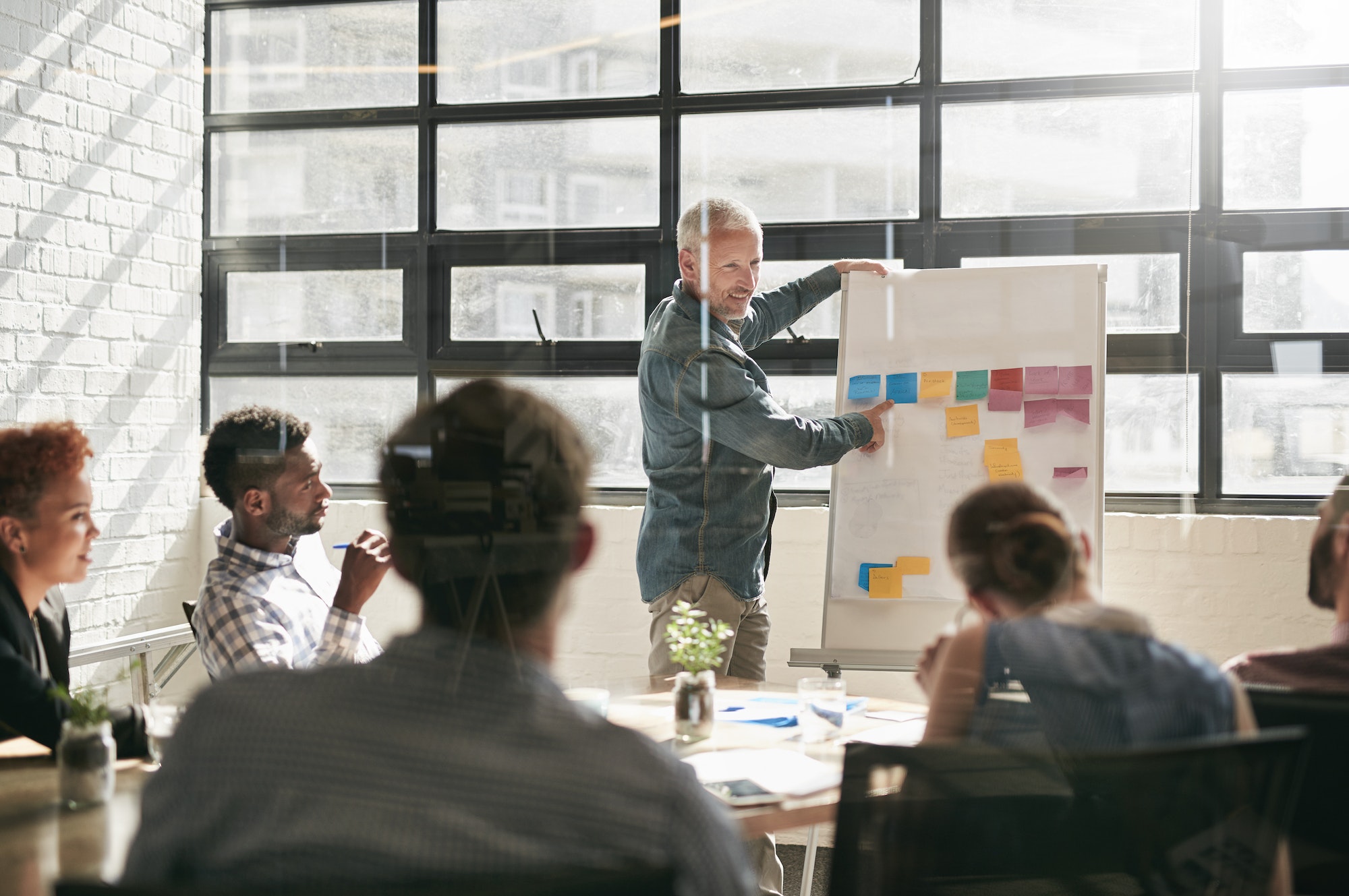 Attitude reflects leadership. Shot of a businessman giving a presentation to his colleagues.